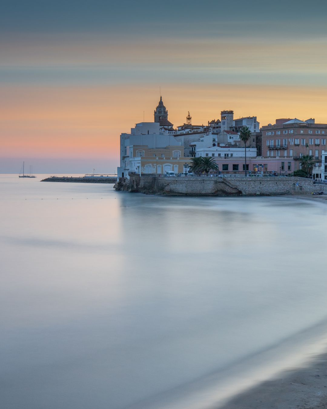 Sitges old town and church at golden hour over the Mediterranean